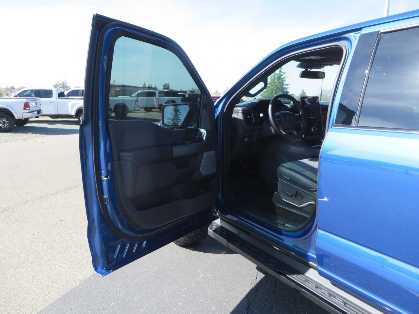 2022 BLUE /BLACK Ford F-150 Lariat Crew Cab 4WD (1FT6W1EV6NW) , located at 2630 Grass Valley Highway, Auburn, CA, 95603, (530) 508-5100, 38.937893, -121.095482 - Tired of gas prices and still want to look cool? Check out this Ford Lightning featuring a RC level kit, Nitto Ridge Grappler tires, Fuel Rebel wheels, Sinister front and rear bumpers, Baja Designs leds, Rigid Industries Leds, Bakflip F1, and window tint. - Photo#28